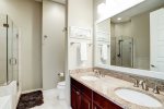 Primary ensuite offers dual sinks, glass walk-in shower and garden tub. 